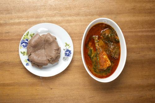 A plate of amala served with ewedu,gbegiri, titus fish and pieces of beef A plate of amala served with ewedu,gbegiri, titus fish and pieces of beef