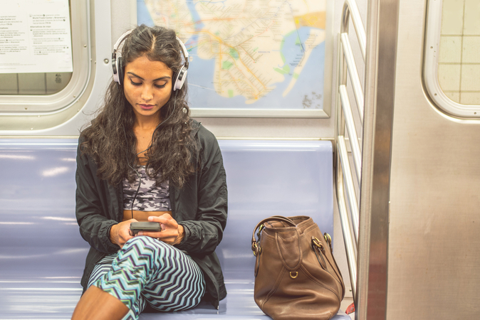 girls in the subway listening to music