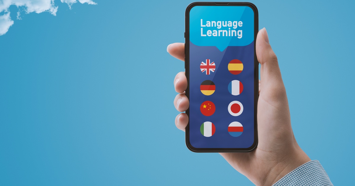A smartphone with the screen displaying language learning options with icons of flags of different countries.