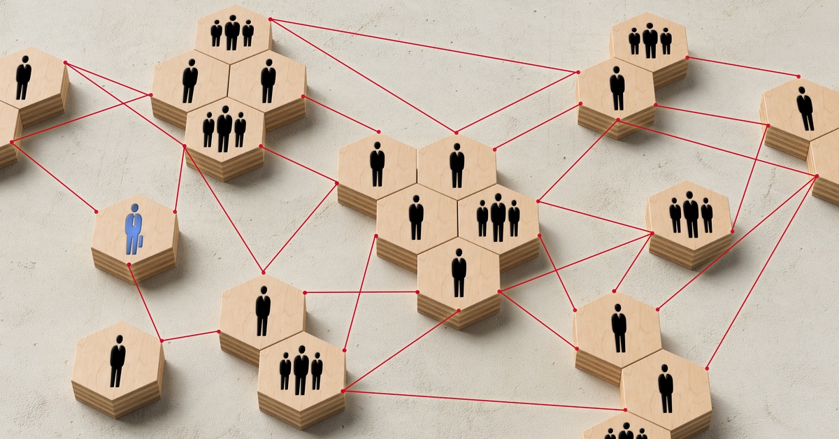 Hexagon-shaped blocks connected by red lines. On the blocks are icons of people wearing business suits.