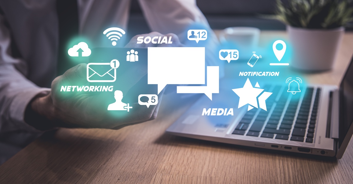 White icons related to social networking positioned over a background of a person wearing a shirt and tie and using a laptop.